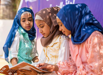Three children reading.